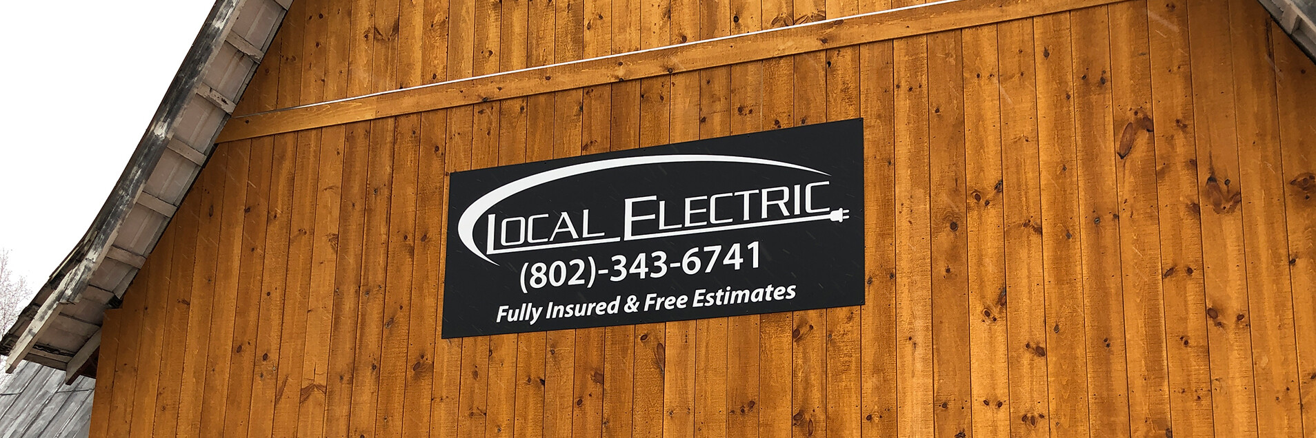 local electric large sign on wooden wall outdoors